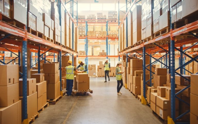 Workers organizing boxes in warehouse