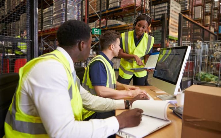 Warehouse team discussing logistics strategy