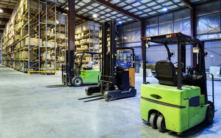 Forklifts in a large warehouse setting