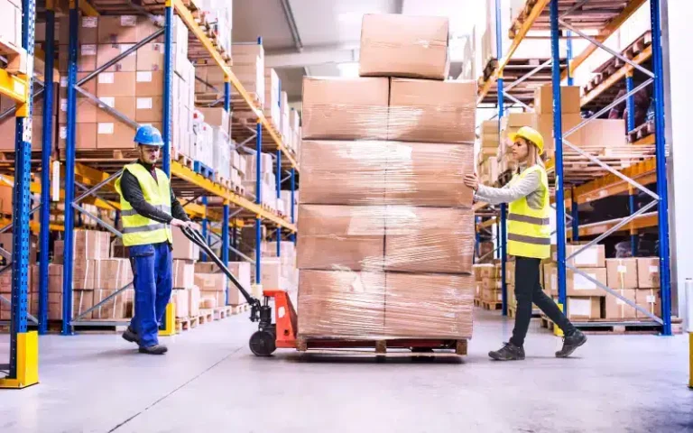 Workers moving boxes in warehouse