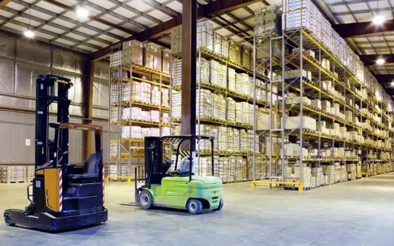 Forklifts in a large warehouse setting.