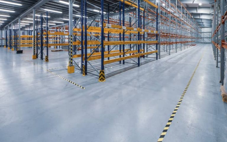 Empty warehouse with metal shelving units