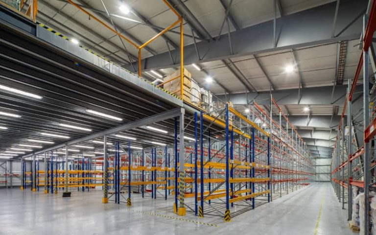 Empty warehouse with shelving units