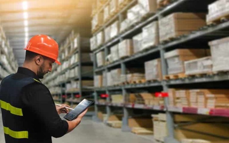 Warehouse worker using tablet device.