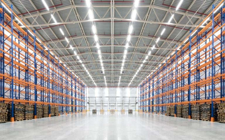 Spacious warehouse with organized shelving.