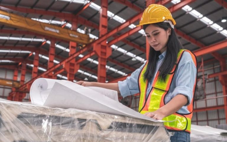 Person reviewing plans in warehouse