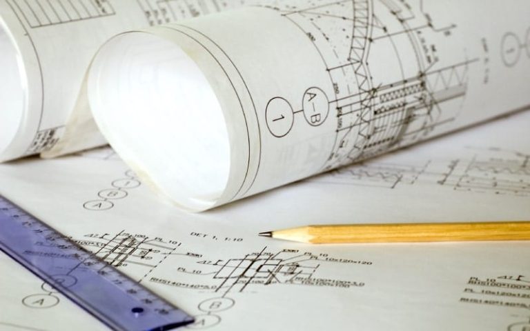 Architectural blueprints and drafting tools.