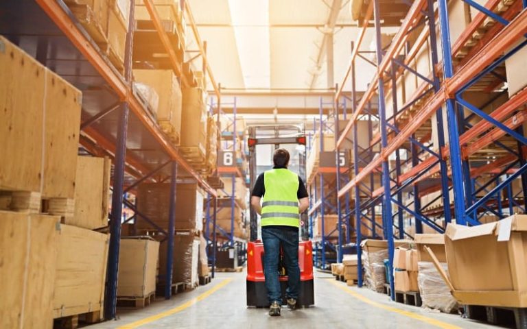 Warehouse worker operating a forklift.