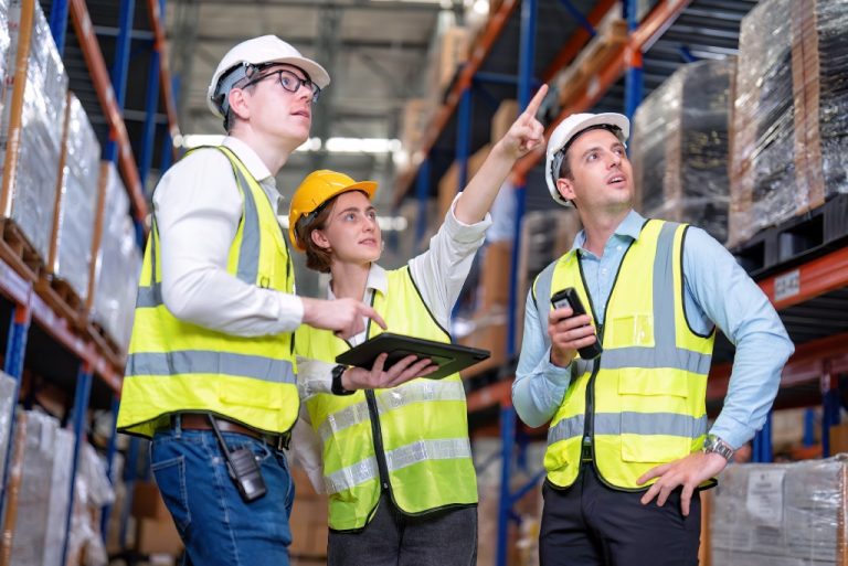 Workers discussing in warehouse environment.