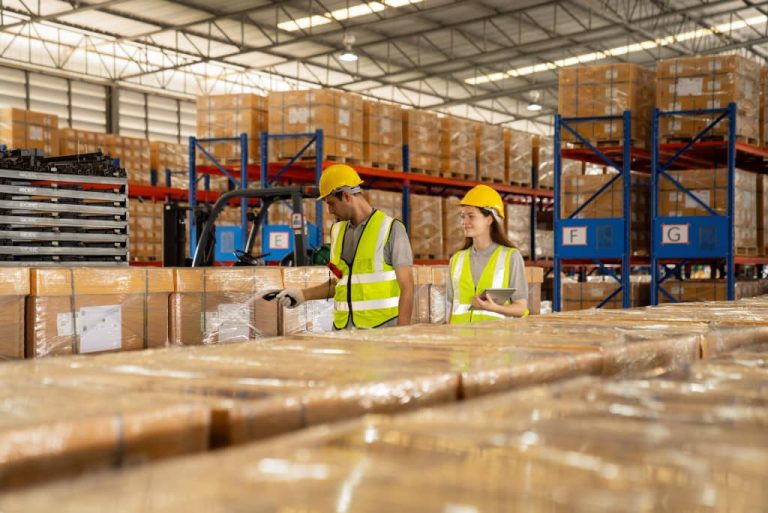 Workers inspecting packages in warehouse