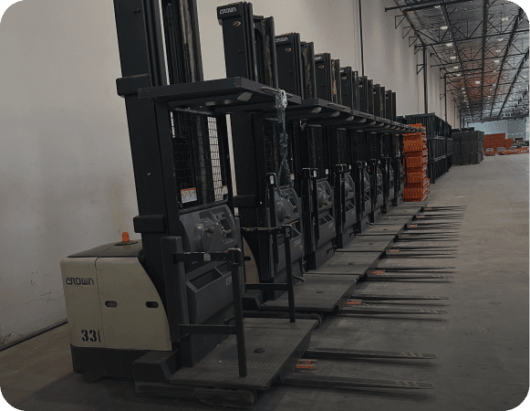 Row of forklifts in warehouse