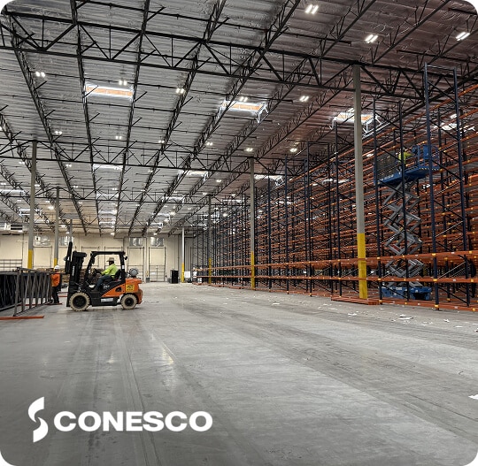 Large warehouse with forklifts and shelving