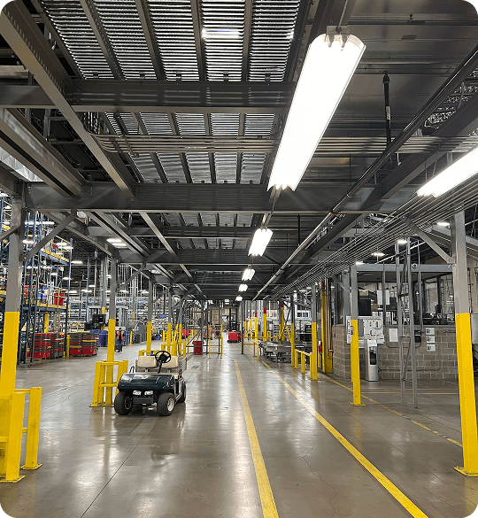 Industrial warehouse with overhead lighting.