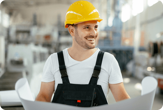 Worker in hard hat with blueprints
