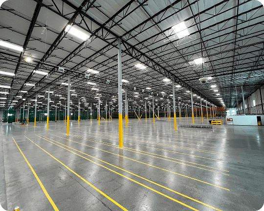 Spacious industrial warehouse with yellow lines.