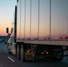 Truck on road at sunset