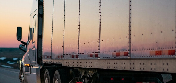 Truck reflecting sunset on highway