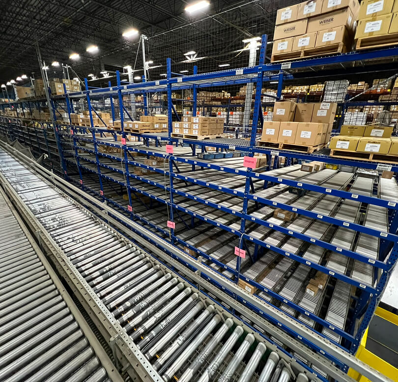Warehouse shelves with conveyor system.
