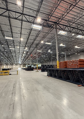 Spacious warehouse with stacked materials.