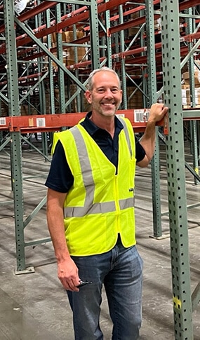 Man in safety vest in warehouse