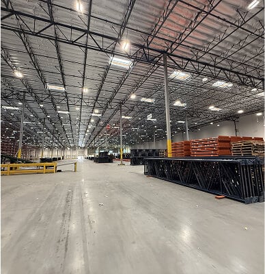 Large, empty warehouse with shelves