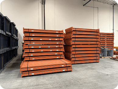 Stacked orange storage racks in warehouse