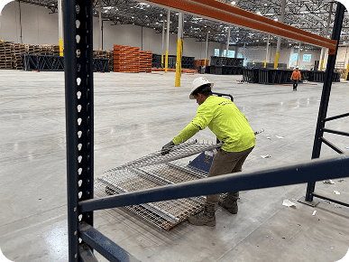 Worker organizing materials in warehouse