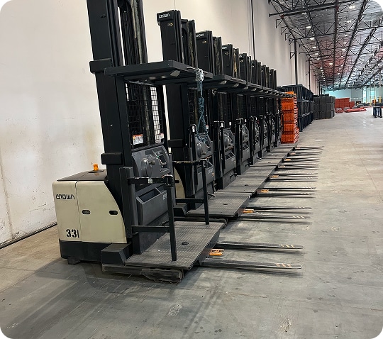 Row of forklifts in warehouse