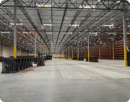 Spacious, empty warehouse interior view.