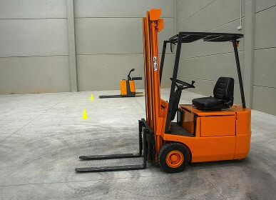 Forklifts in empty warehouse space