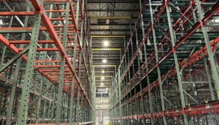 Empty warehouse with tall shelving units