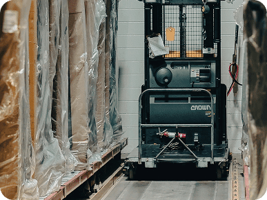 Forklift navigating narrow warehouse aisle
