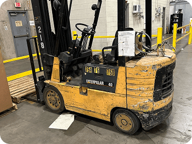 Old Caterpillar forklift in warehouse