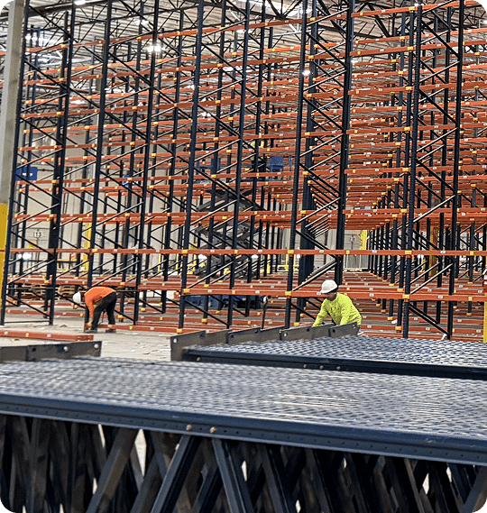 Workers assembling industrial shelving units