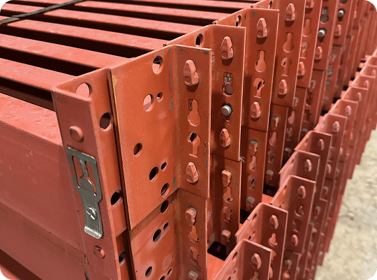 Stacked red metal shelving brackets