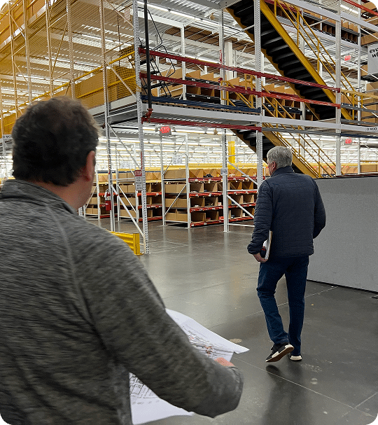 Two men walking in warehouse