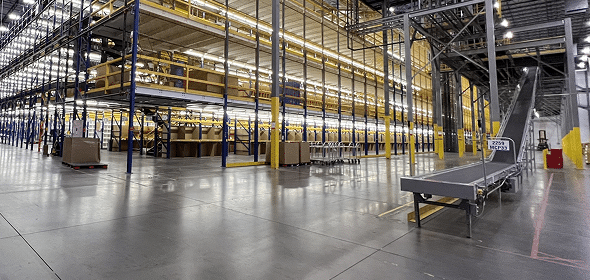 Large, empty warehouse with conveyor belt